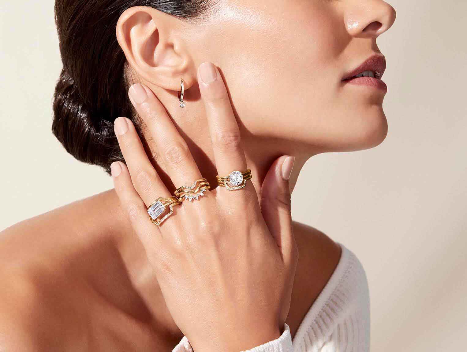 Model wearing unique diamond ring stacks