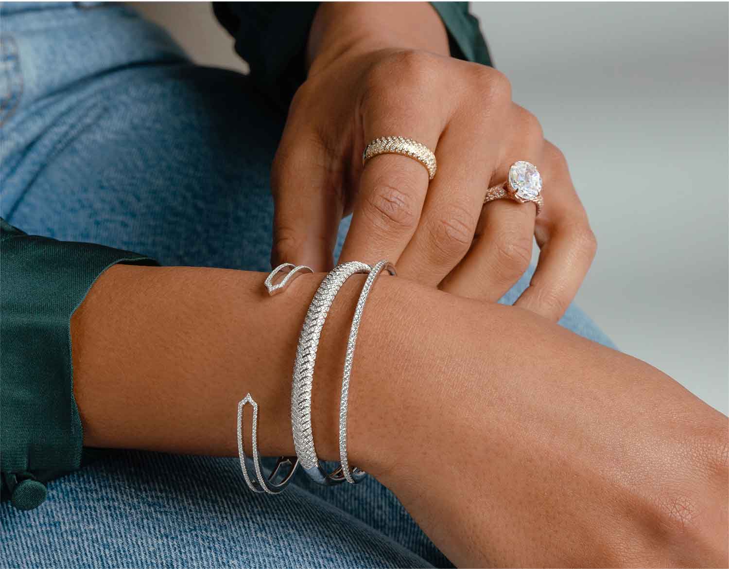 Woman wearing distinctive stack of diamond bracelets