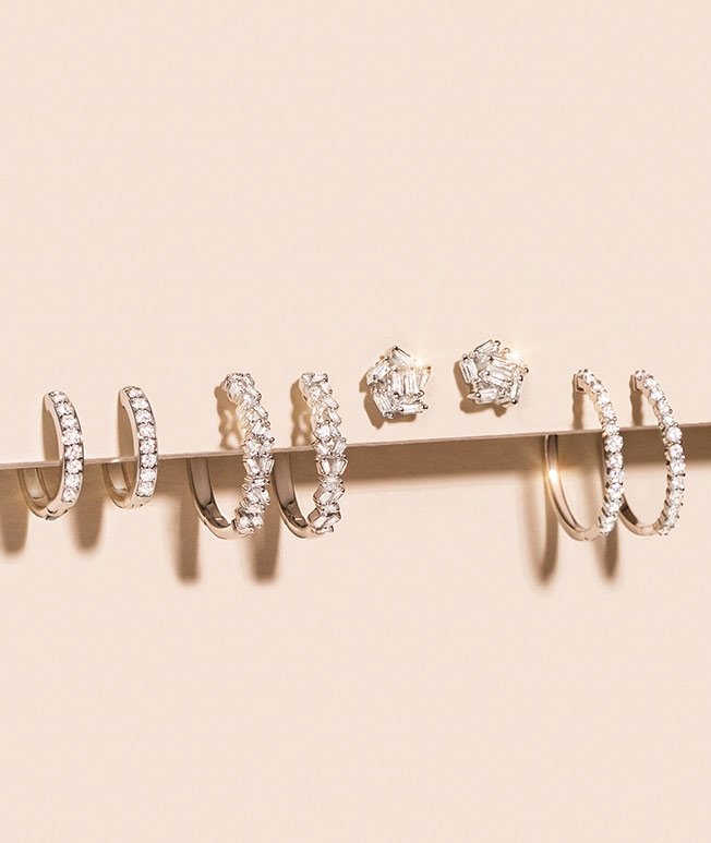 Lustrous white gold diamond hoop and stud earrings.