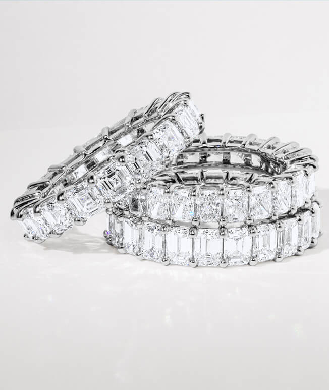Stack of luxe diamond eternity rings.
