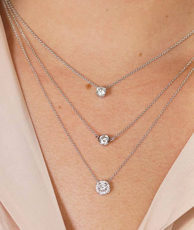 Layered lustrous white gold diamond solitaire necklaces