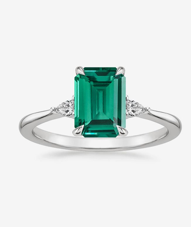 Emerald engagement ring with diamond accents