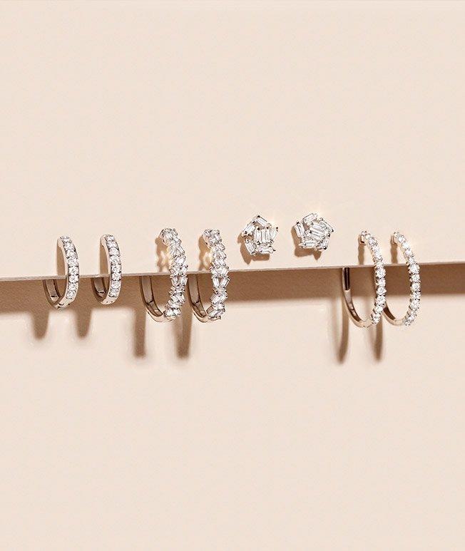White gold diamond hoops and diamond stud earrings.