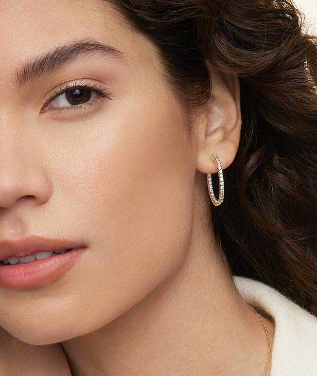 Model wearing diamond hoop earrings