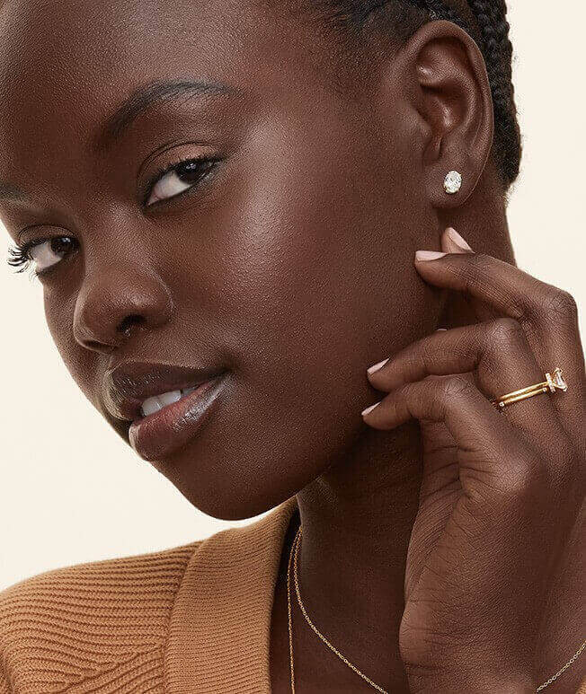 Model wearing diamond stud earrings