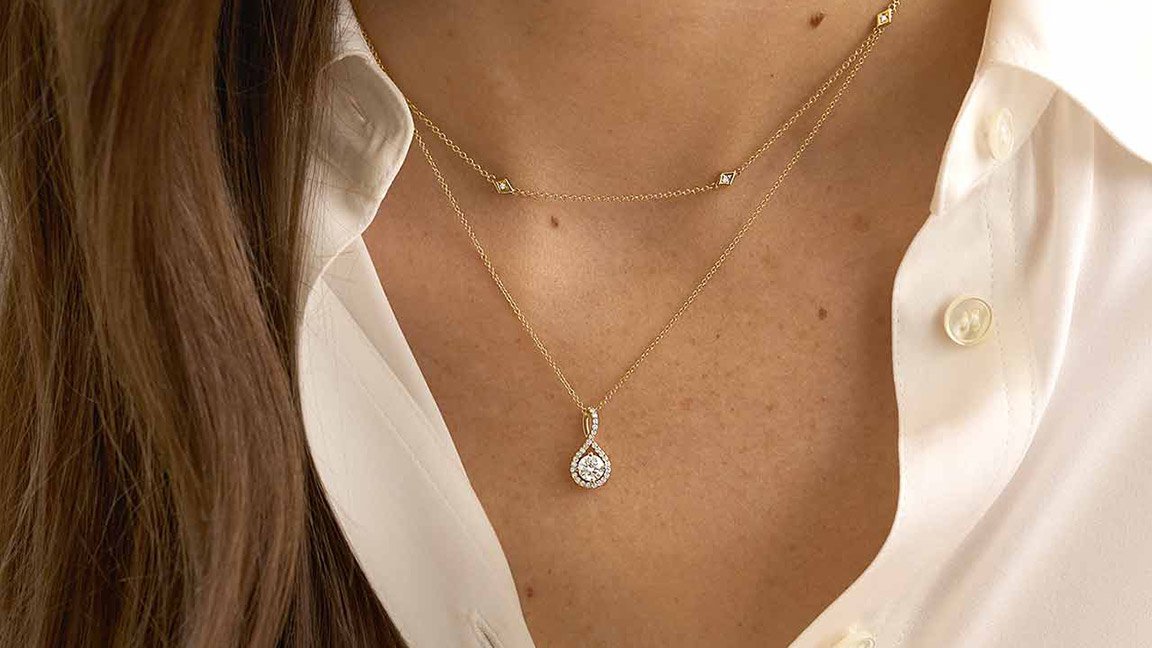 Woman wearing a create your own diamond necklace.