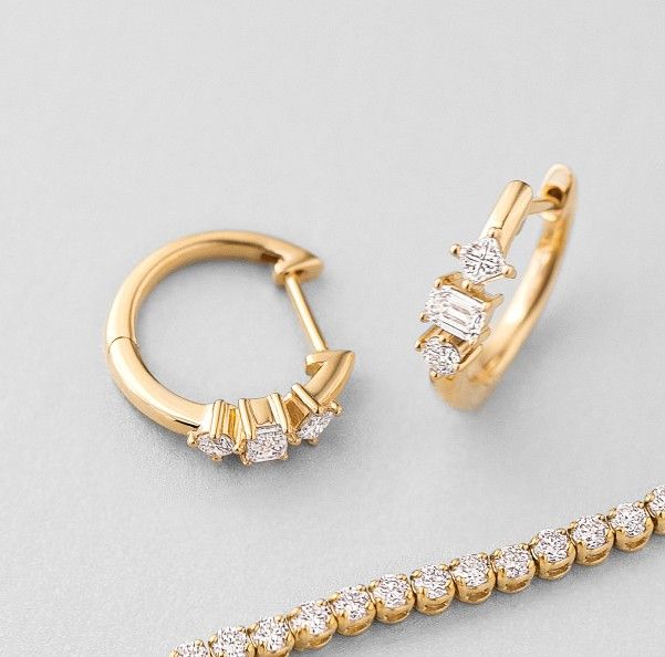 Gold diamond hoop earrings and tennis bracelet.