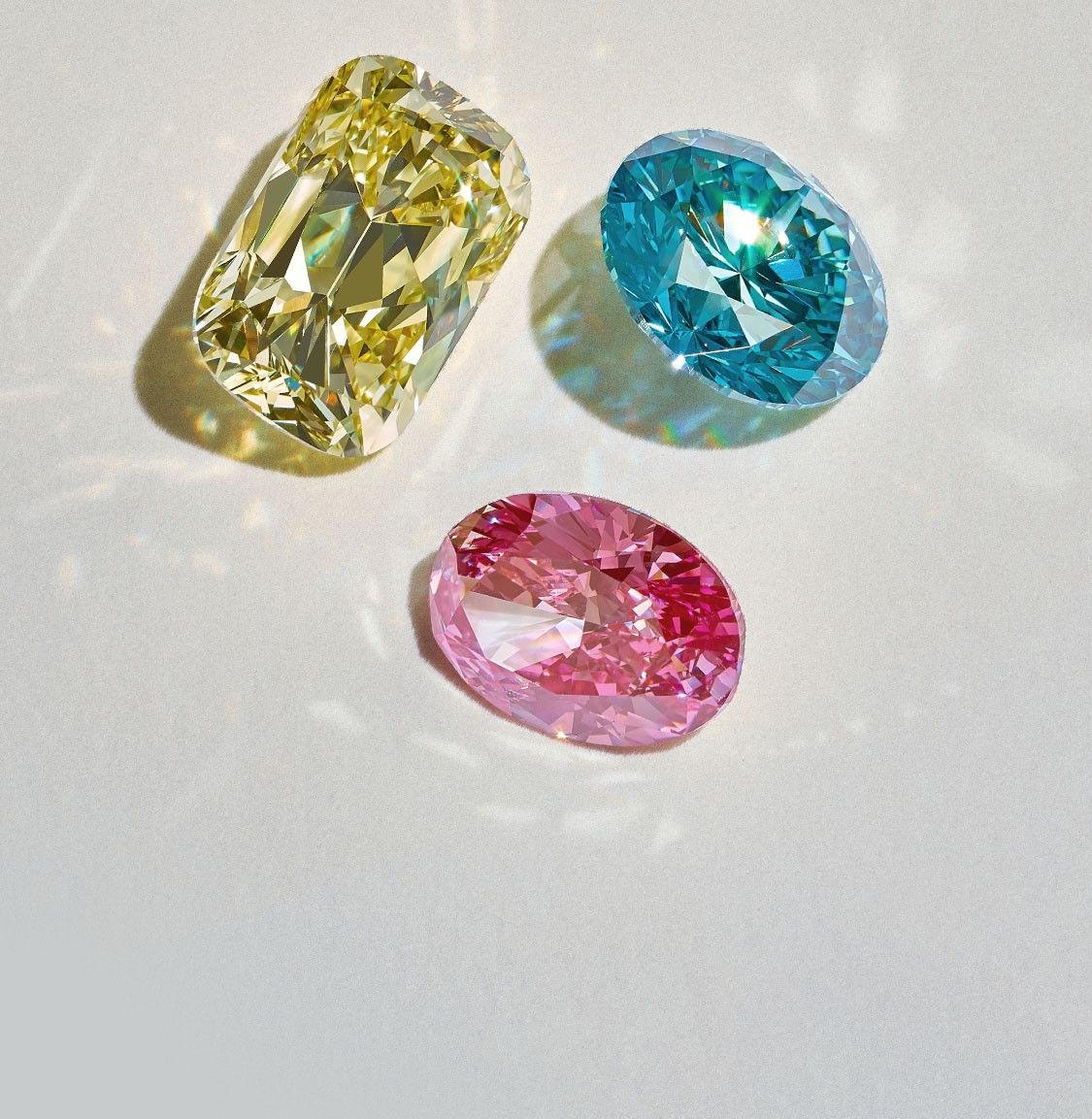 Yellow, blue, and pink loose colored diamonds.