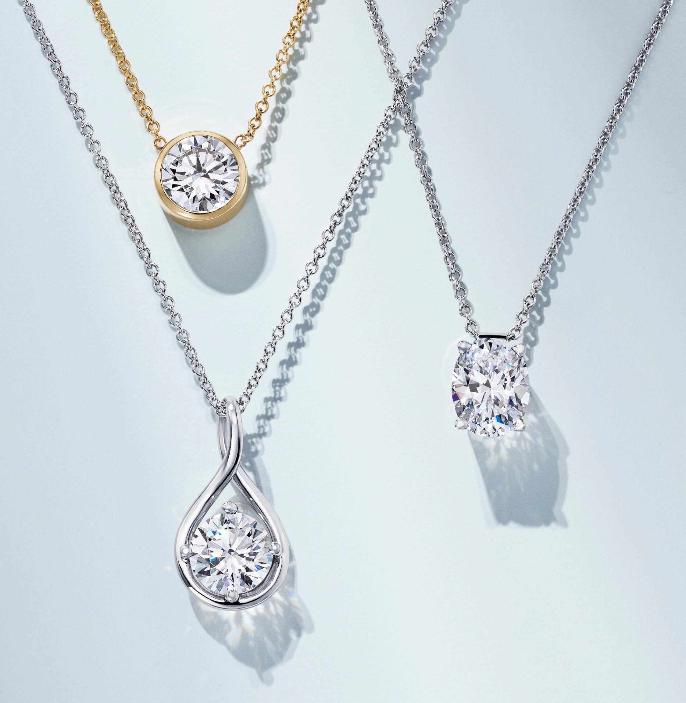 Diamond solitaire necklaces in a variety of settings.