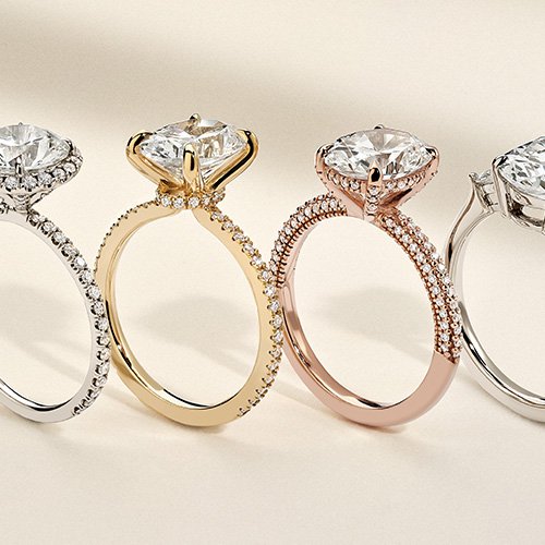 Assortment of diamond accented engagement rings in a variety of metal types.