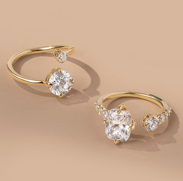 Assortment of diamond, yellow gold open styled engagement rings.