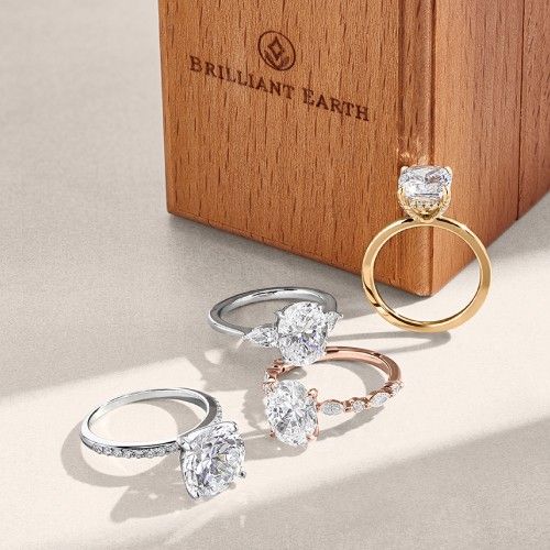 Assortment of diamond engagement rings in different metal types.