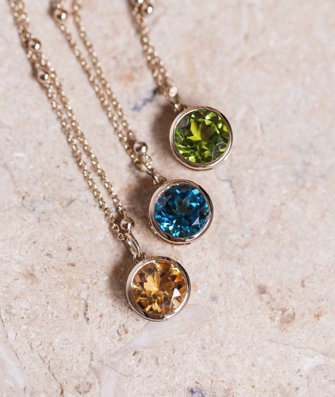 Assortment of birthstone solitaire necklaces.
