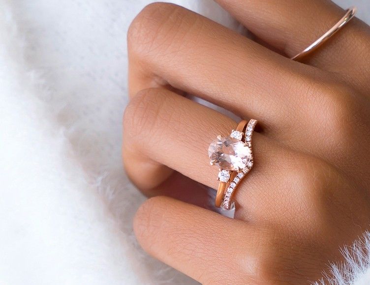 Model wearing diamond engagement ring and contoured wedding ring.