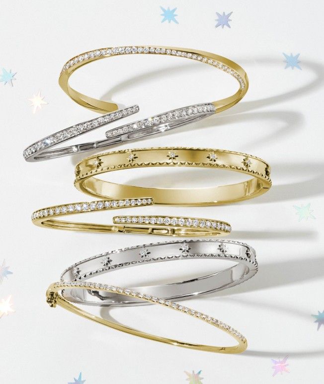 Assortment of yellow gold and silver diamond bracelets, perfect gift option for the trendsetter.