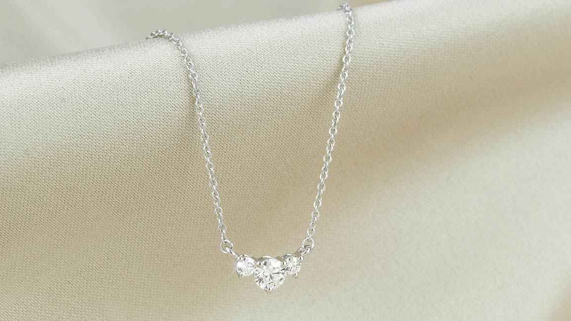 Three-stone diamond necklace on white gold chain