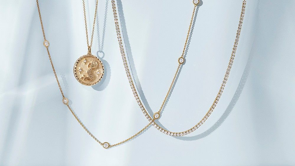 Assortment of diamond bezel, tennis, and medallion necklaces.