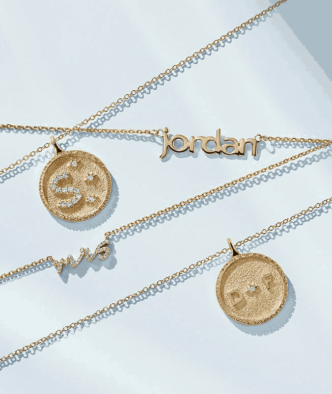 Assortment of medallion and personalized necklaces.