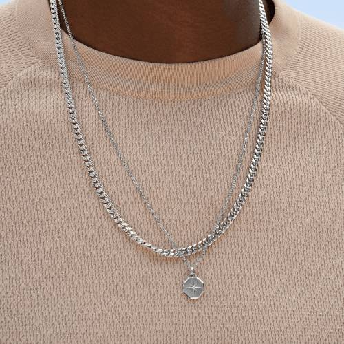 Model wearing men’s chain and medallion necklaces.