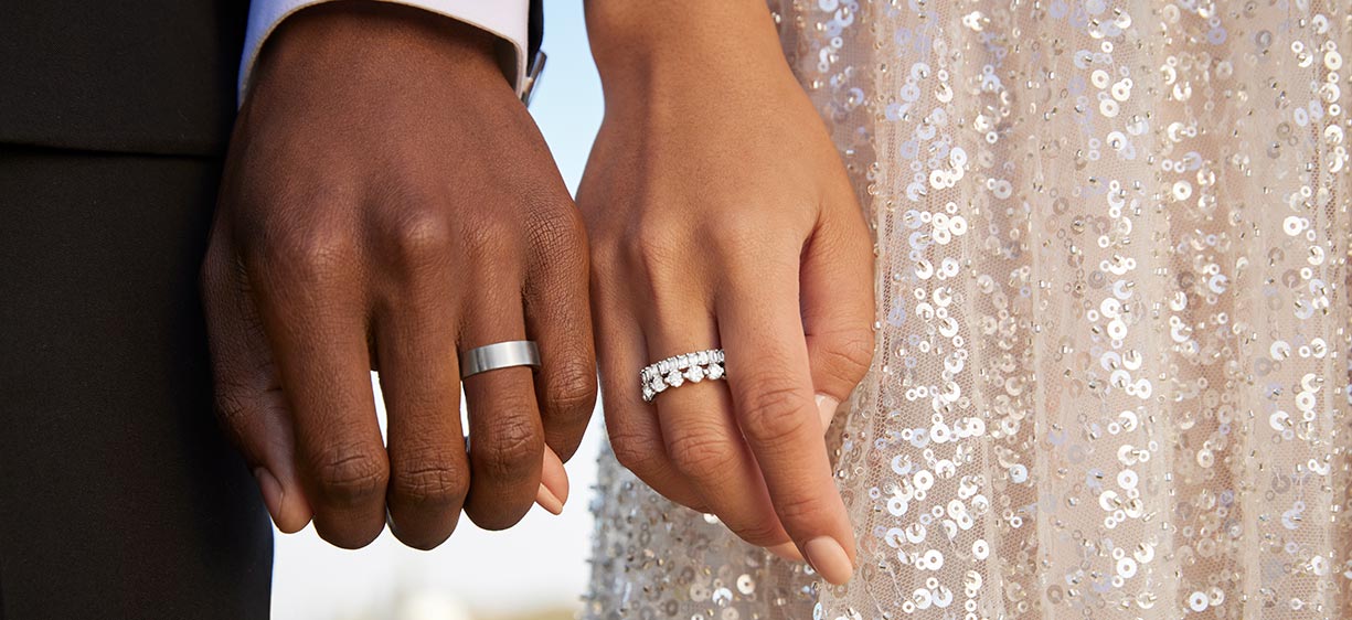 Couple wearing wedding rings.