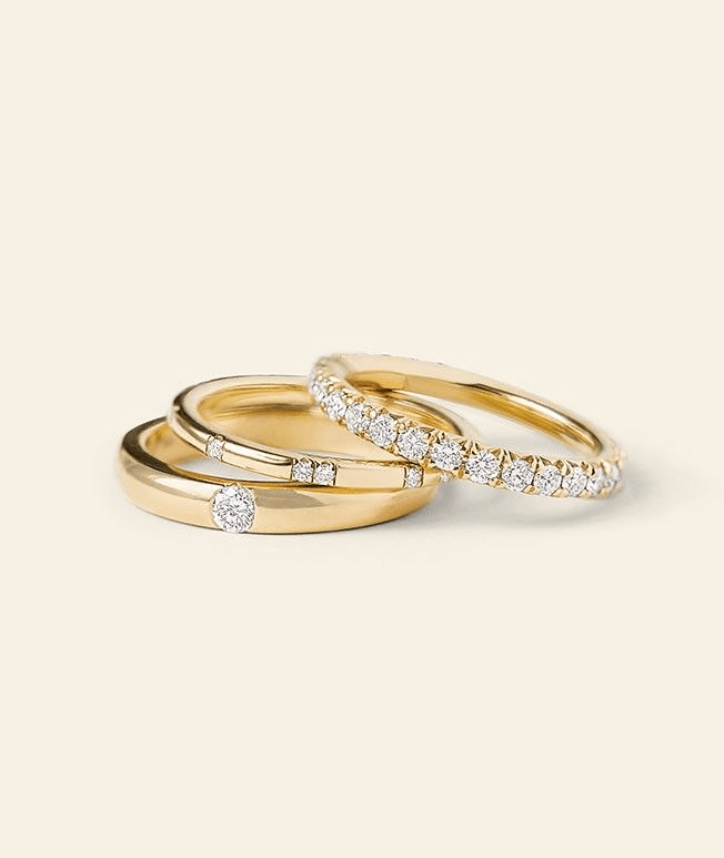 Stack of yellow gold wedding rings with diamond accents