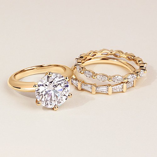Variety of gold diamond engagement ring and wedding bands.