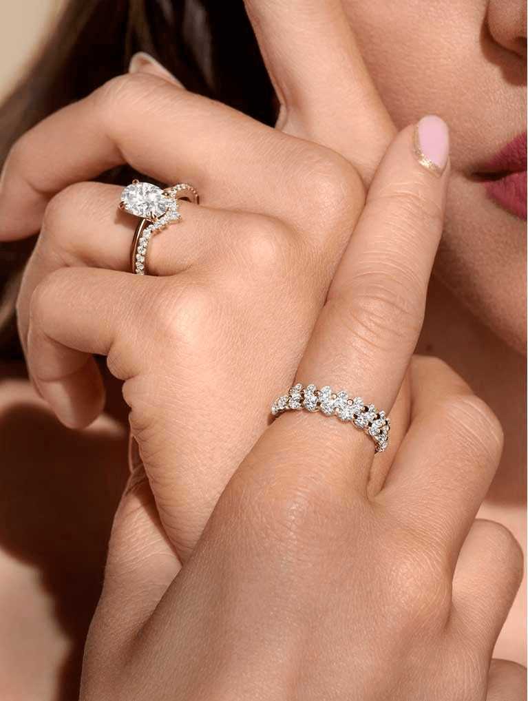 Model wearing an engagement ring paired with a contoured wedding ring